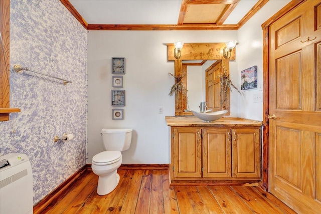 bathroom featuring hardwood / wood-style floors, vanity, toilet, and crown molding