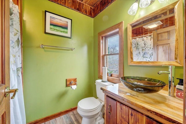 bathroom with a shower with shower curtain, wood ceiling, vanity, hardwood / wood-style floors, and toilet