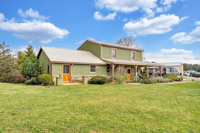 rear view of property featuring a porch and a lawn
