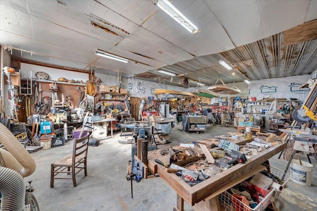 misc room featuring concrete flooring and a workshop area