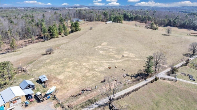 drone / aerial view featuring a rural view and a forest view
