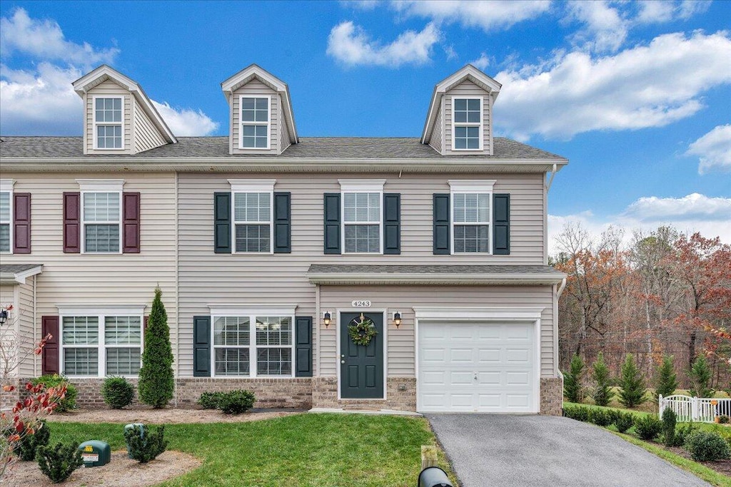 view of front of house featuring a garage and a front lawn