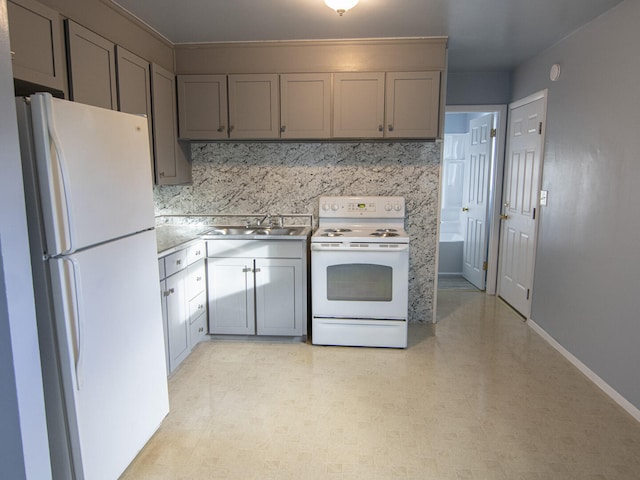 kitchen with backsplash, gray cabinetry, white appliances, and sink