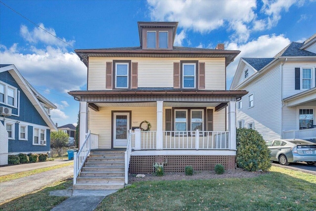 view of front of home featuring covered porch and a front yard