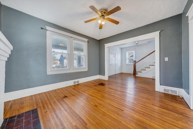 spare room with wood-type flooring, a textured ceiling, and ceiling fan