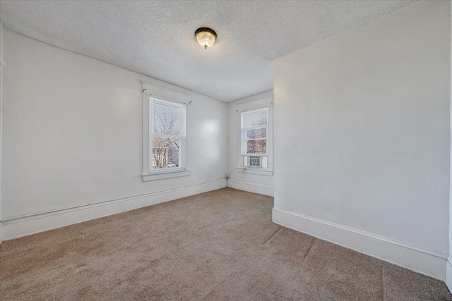 carpeted spare room with a textured ceiling