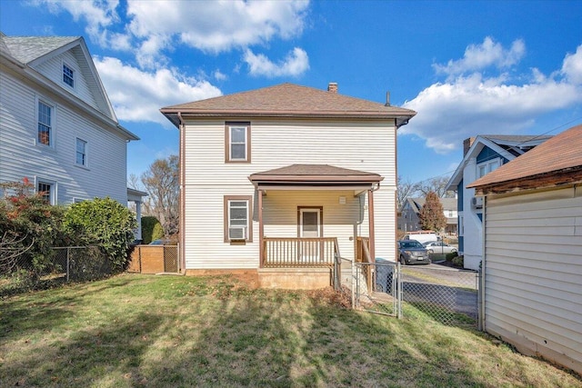 rear view of house with a porch, a yard, and cooling unit