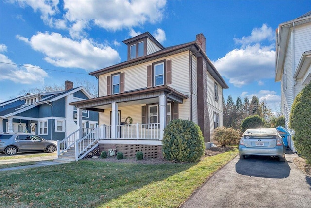 view of front of property featuring covered porch and a front yard