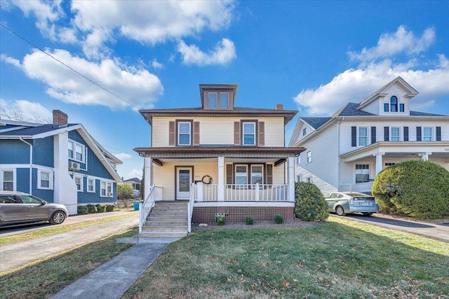 view of front of property with a front lawn and covered porch