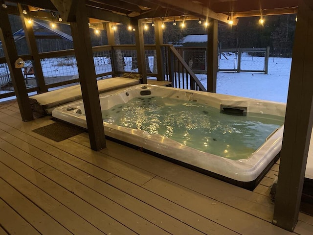 wooden terrace featuring an outdoor hot tub