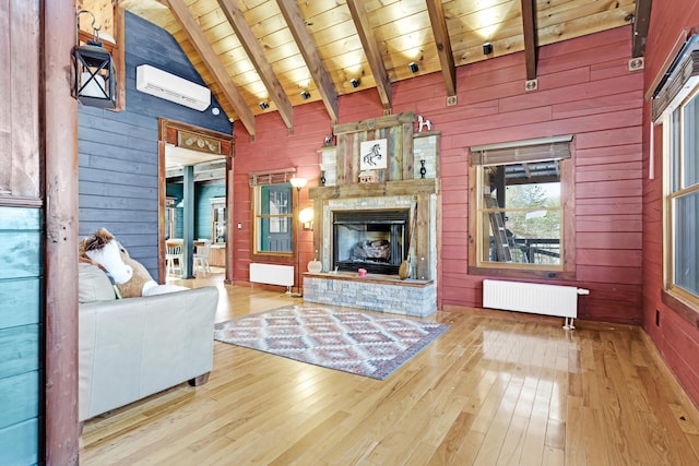 living room with wood ceiling, radiator, beam ceiling, and wooden walls