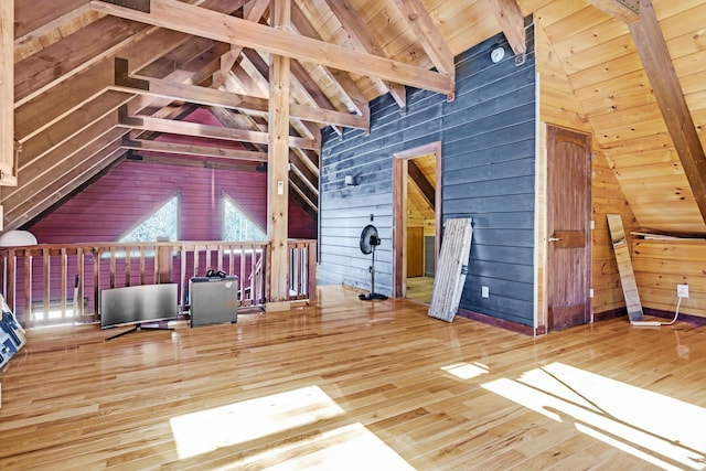 bonus room featuring hardwood / wood-style floors, wood ceiling, vaulted ceiling with beams, and wood walls