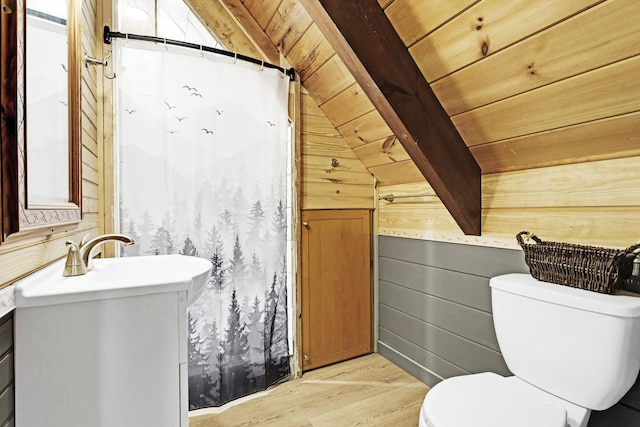 bathroom featuring wood ceiling, hardwood / wood-style flooring, wooden walls, vanity, and lofted ceiling with beams