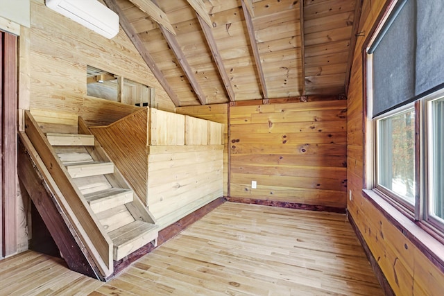 interior space featuring wood ceiling, wooden walls, lofted ceiling with beams, and hardwood / wood-style flooring