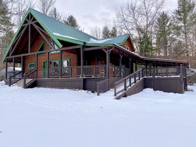 snow covered property featuring covered porch