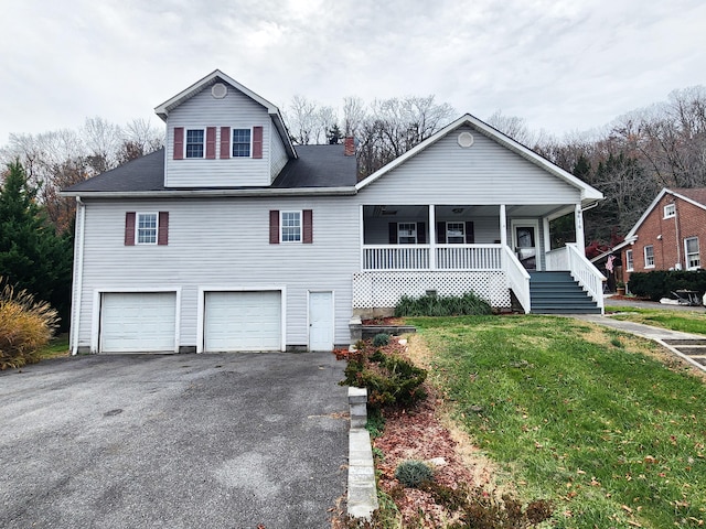 view of front of home with covered porch, a garage, and a front lawn