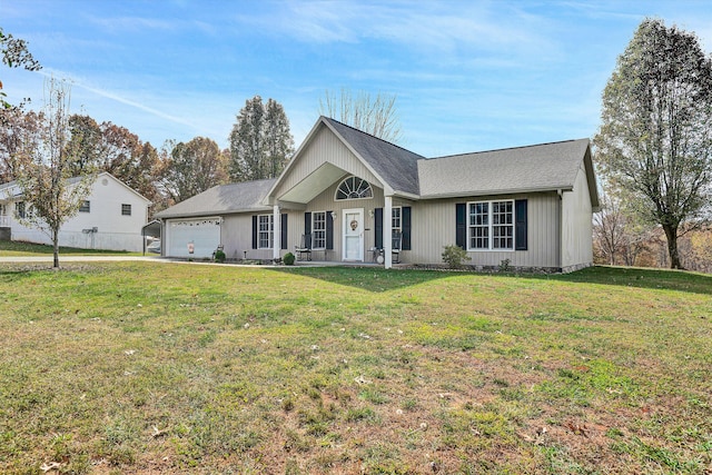 ranch-style house featuring a garage and a front lawn