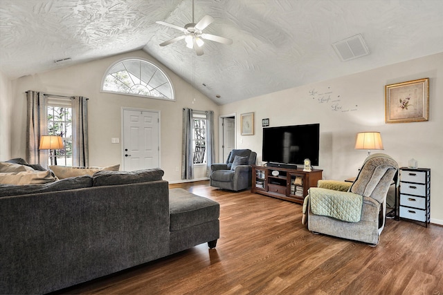 living room featuring ceiling fan, lofted ceiling, and hardwood / wood-style flooring