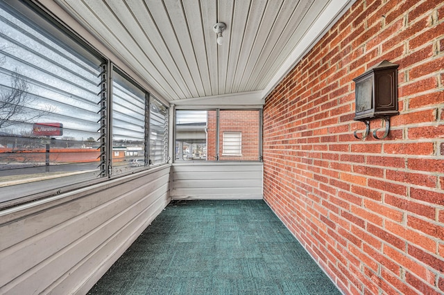 unfurnished sunroom with lofted ceiling