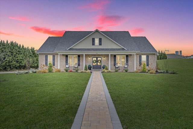 view of front of house featuring a lawn and a porch