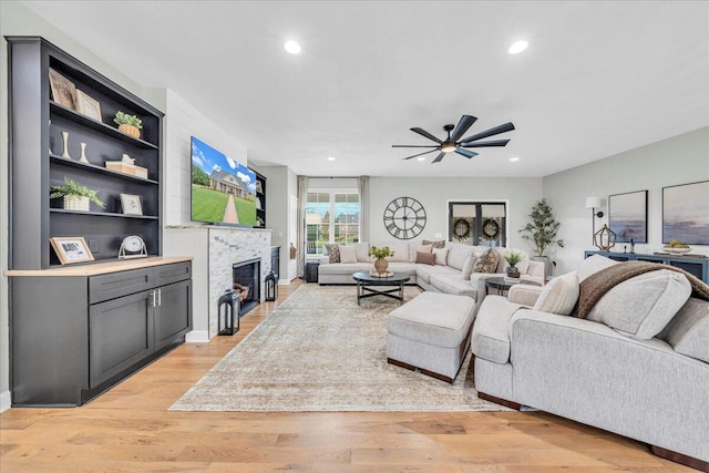 living room featuring ceiling fan and light hardwood / wood-style floors