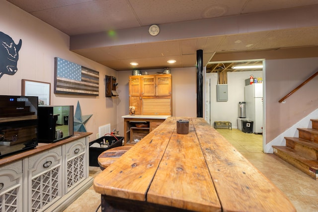 kitchen featuring electric panel and white fridge