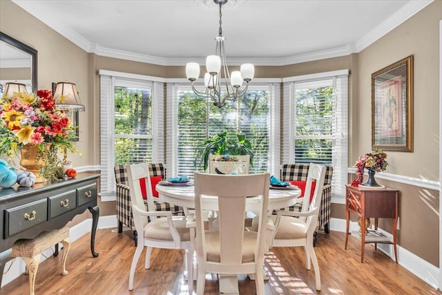 dining area featuring light hardwood / wood-style flooring, a wealth of natural light, and ornamental molding