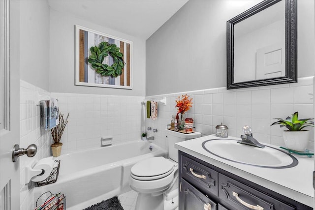 bathroom with vanity, toilet, tile walls, and a tub