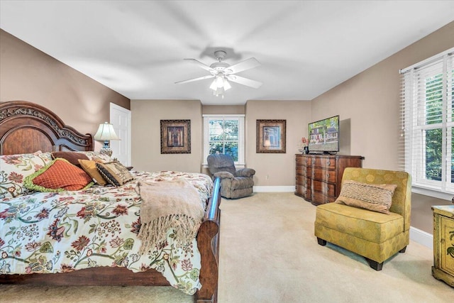 carpeted bedroom with multiple windows and ceiling fan