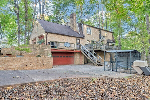 rear view of house featuring a wooden deck