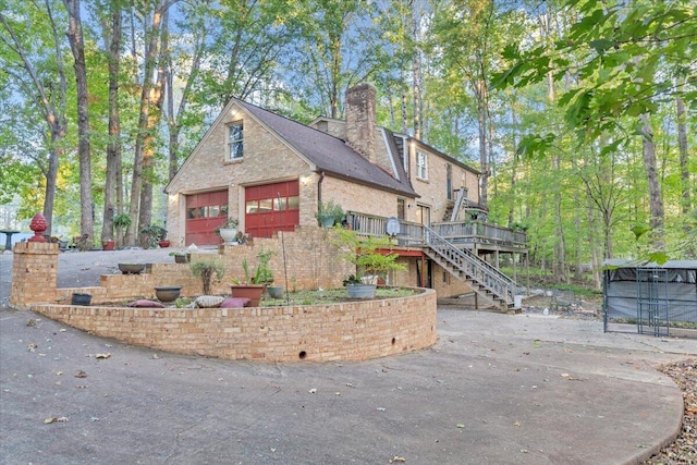 view of front of property with a wooden deck and a garage