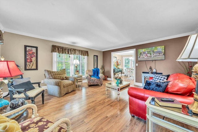 living room featuring a wealth of natural light, light hardwood / wood-style flooring, and ornamental molding