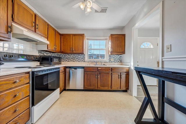 kitchen featuring backsplash, sink, stainless steel dishwasher, ceiling fan, and white electric range oven