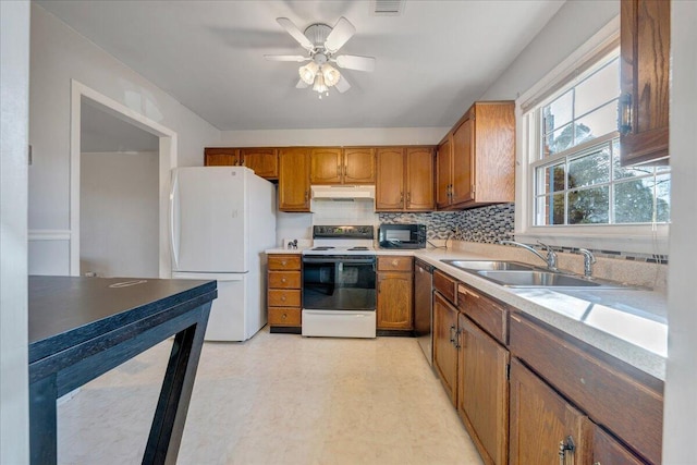 kitchen featuring decorative backsplash, ceiling fan, white appliances, and sink