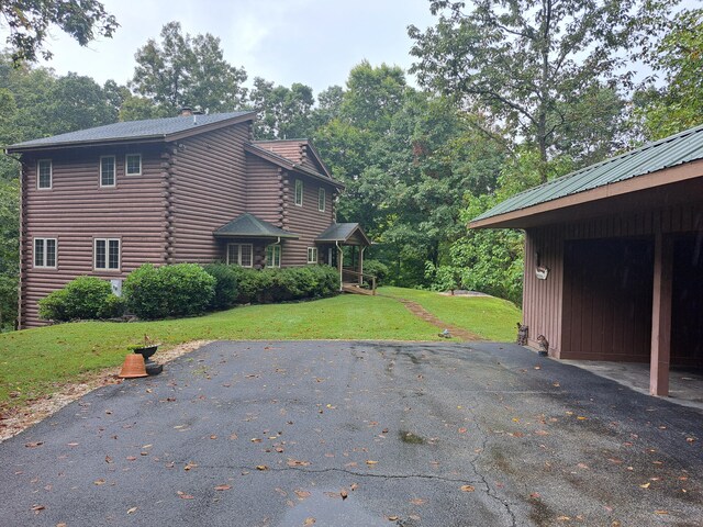 log cabin with a front lawn