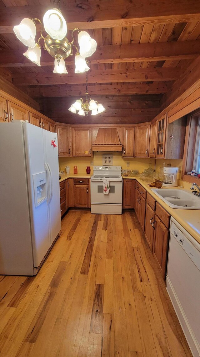 kitchen featuring glass insert cabinets, light countertops, dishwasher, and a sink