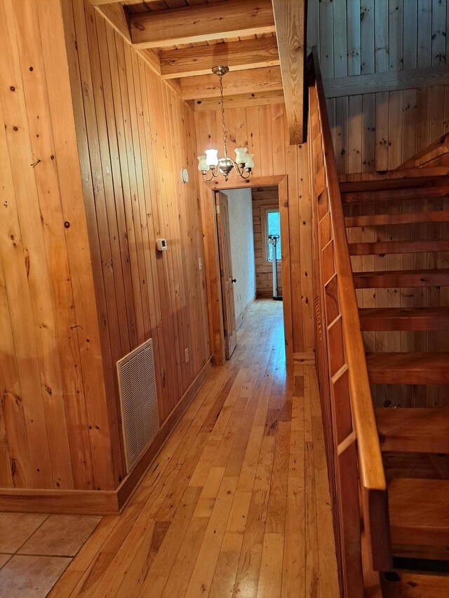 interior space with a chandelier, light wood-style flooring, and a healthy amount of sunlight