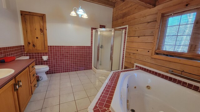 full bath featuring wooden walls, vanity, beamed ceiling, tile patterned floors, and a stall shower