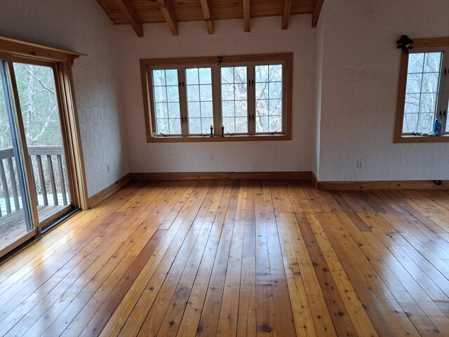 unfurnished room featuring light wood-type flooring, visible vents, and baseboards