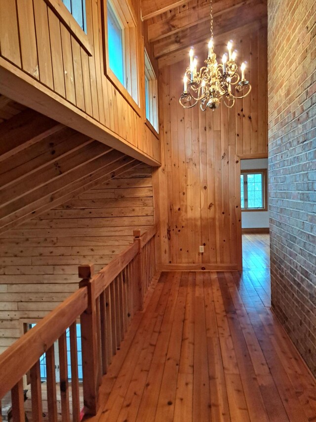 spare room with vaulted ceiling with beams, visible vents, wood ceiling, wood finished floors, and baseboards