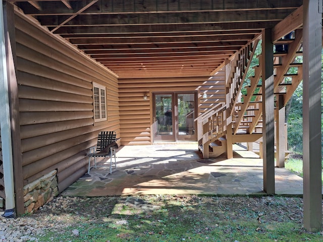 view of patio featuring french doors and stairway