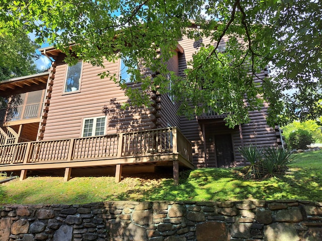 rear view of property with a deck and log siding