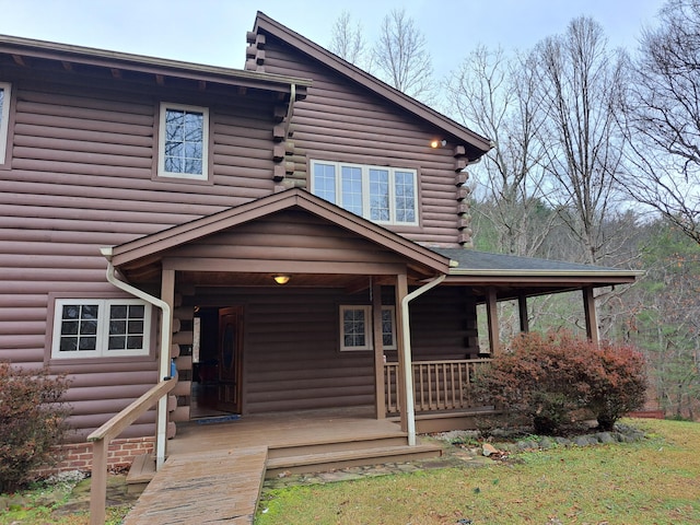 view of front of house with log exterior and a porch