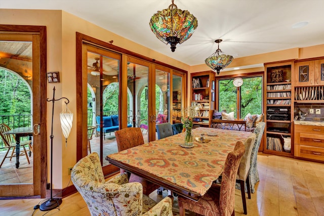 dining room featuring french doors and light wood-type flooring