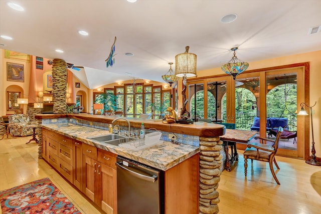 kitchen featuring dishwasher, a center island with sink, light hardwood / wood-style flooring, and sink