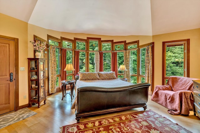 bedroom featuring vaulted ceiling and light hardwood / wood-style flooring