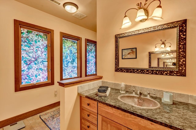 bathroom with tile patterned floors and vanity