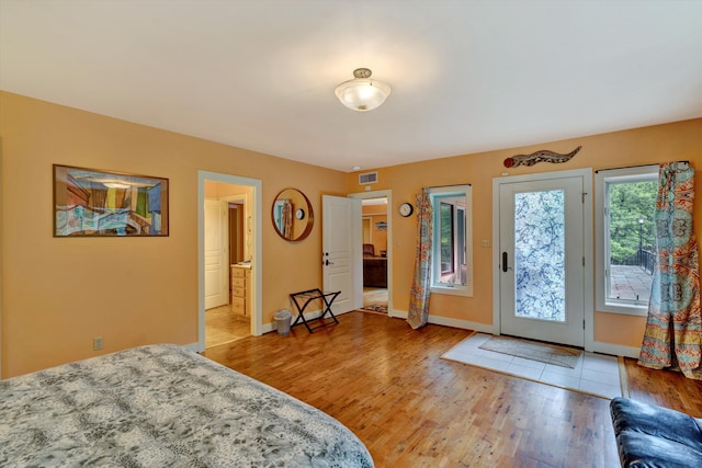 bedroom with hardwood / wood-style flooring and access to outside