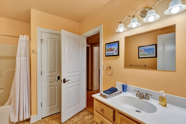 bathroom featuring vanity and curtained shower