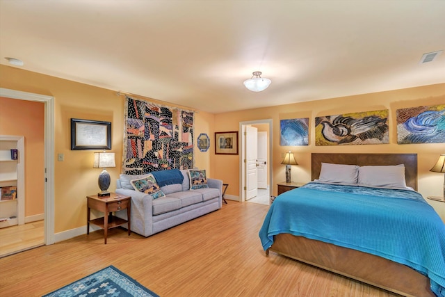 bedroom with hardwood / wood-style flooring